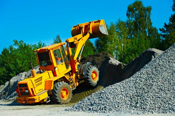 heavy construction loader bulldozer moving breakstone at construction area